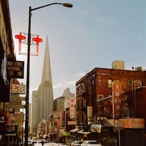 Exterior view of building and skyscraper with car parked on street, San Francisco, California, United States Of America