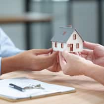 Real Estate Deal with House Model, Documents and Keys