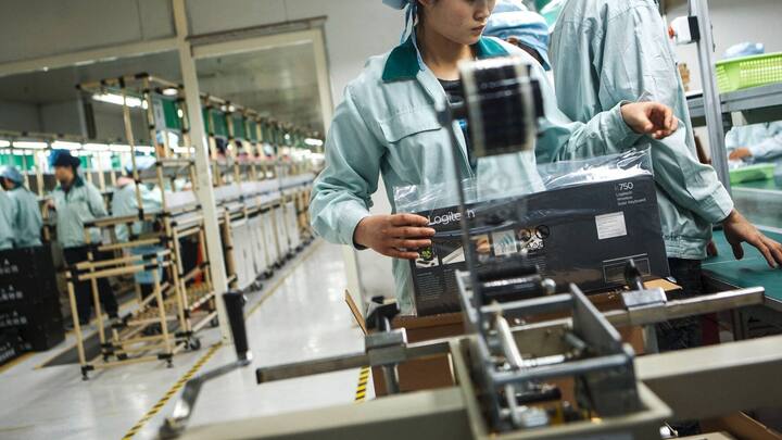 Workers package keyboards at the Logitech International SA factory in Suzhou, Jiangsu Province, China, on Friday, March 2, 2012. Logitech manufactures personal computer input devices including computer mice and keyboards. Photographer: Nelson Ching/Bloomberg