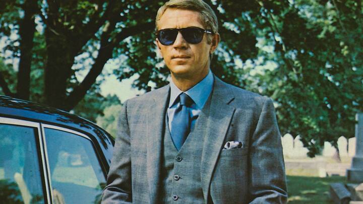 Steve McQueen (1930-1980), US actor, wearing sunglasses with a grey suit, a blue shirt and dark blue tie in a publicity image issued for the film, 'The Thomas Crown Affair', USA, 1968. The crime drama, directed by Norman Jewison, starred McQueen as 'Thomas Crown'. (Photo by Silver Screen Collection/Getty Images)