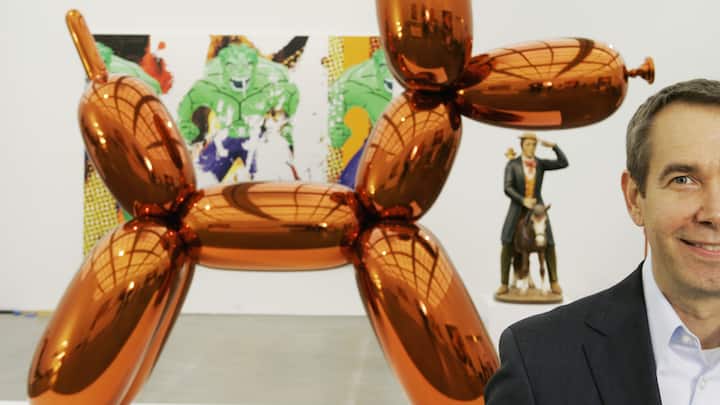 FILE - In this Thursday, May 29, 2008 file photo, artist Jeff Koons poses beside one of his works, "Balloon Dog," on display at Chicago's Museum of Contemporary Art. The more than 10-foot-high chromium stainless steel sculpture of a balloon-animal dog has an orange metallic coating and is part of an exhibit of about 60 other sculptures and paintings by Koons. (AP Photo/Charles Rex Arbogast)