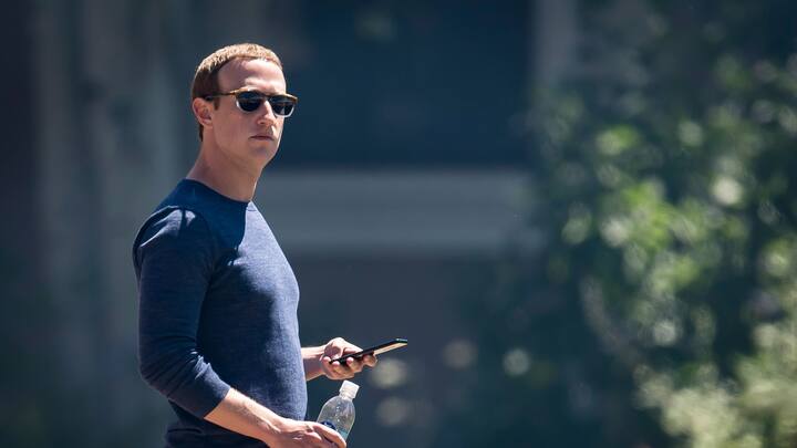 Mark Zuckerberg, chief executive officer and founder of Facebook Inc., holds his phone after the morning session at the Allen & Co. Media and Technology Conference in Sun Valley, Idaho, U.S., on Friday, July 13, 2018. The 35th annual Allen & Co. conference gathers many of America's wealthiest and most powerful people in media, technology, and sports. Photographer: David Paul Morris/Bloomberg