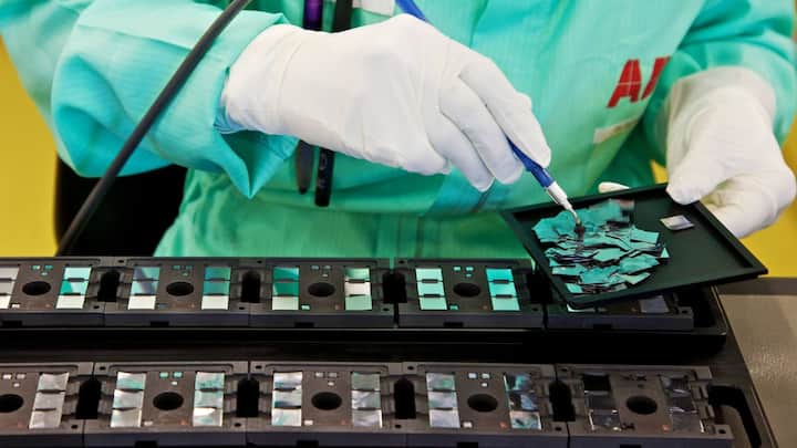 A technician prepares the mounting of ABB-made silicon chips onto HiPak substrates prior to soldering at the ABB AG semi-conductor plant in Lenzburg, Switzerland, on Tuesday, Aug. 30, 2011. ABB AG is the world's largest builder of electricity grids. Photographer: Gianluca Colla/Bloomberg