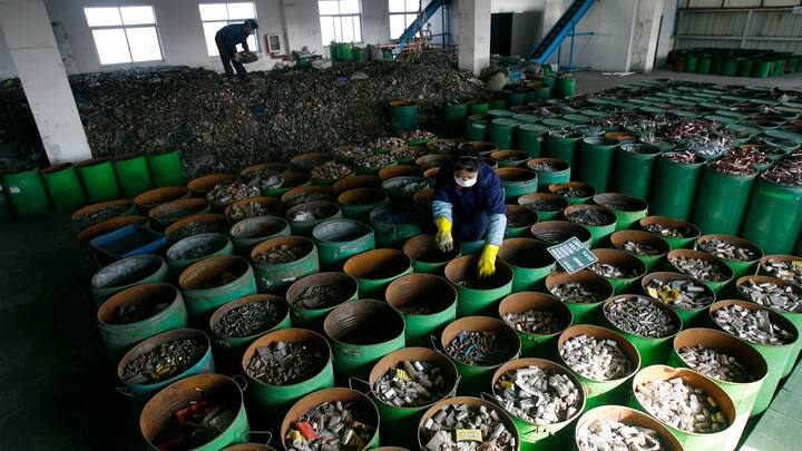 Workers sort batteries in an electronic waste recycling factory in Jingmen, Hubei province December 3, 2009. VCP (Photo by Jie Zhao/Corbis via Getty Images)