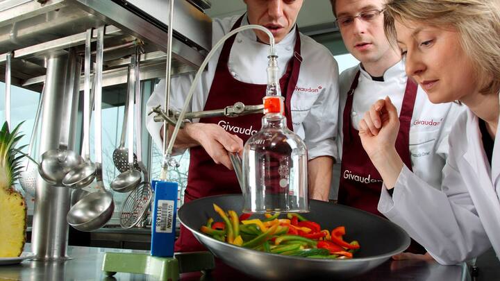 Plus grand producteur d'aromes au monde. Employes de laboratoire, laborantins, cloche en verre, operation de capture de molecules d'aromes de legume sur des lamelles de poivron