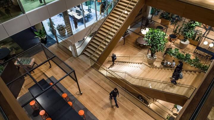 Attendees descend the central atrium staircases inside the new ING Groep NV Cedar campus headquarters at Cumulus Park in Amsterdam, Netherlands, on Tuesday, Jan. 7, 2020. The Dutch bank is scheduled to report full year earnings on February, 6. Photographer: Geert Vanden Wijngaert/Bloomberg
