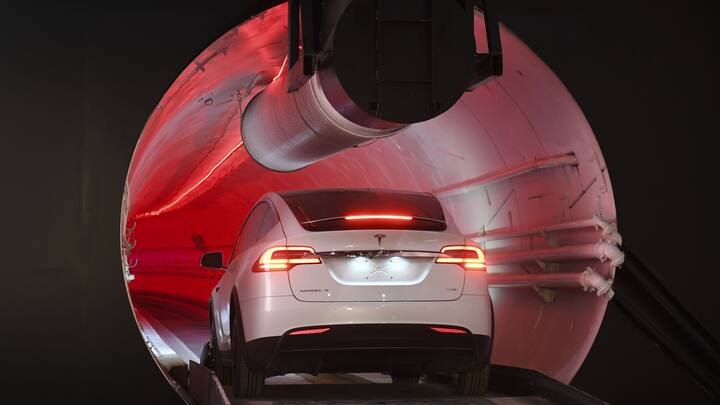 A modified Tesla Inc. Model X drives into the tunnel entrance at an unveiling event for the Boring Co. Hawthorne test tunnel in Hawthorne, California, U.S., on Tuesday, Dec. 18, 2018. Elon MuskÂ took the wraps off hisÂ BoringÂ Co.'s first completed test tunnel on Tuesday, with a lot of razzle-dazzle, the admission he had spent $40 million of his own money on the project and a surprise twist in the underlying technology. Photographer: Robyn Beck/Pool via Bloomberg via Bloomberg