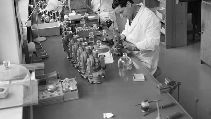 Mitarbeiter der Firma Wild Heerbrugg AG, Hersteller optischer Vermessungsinstrumente, Labor- und Stereo-Mikroskopen, Reisszeugen und Instrumenten fuer die Photogrammetrie, aufgenommen im Kanton St.Gallen am 9. November 1960. Die von der Montage vormontierten Wild-Theodolithen (vorne T16, hinten T29) werden von den Justierern in 10er-Serien fertig justiert. (KEYSTONE/PHOTOPRESS-ARCHIV/Vogt)