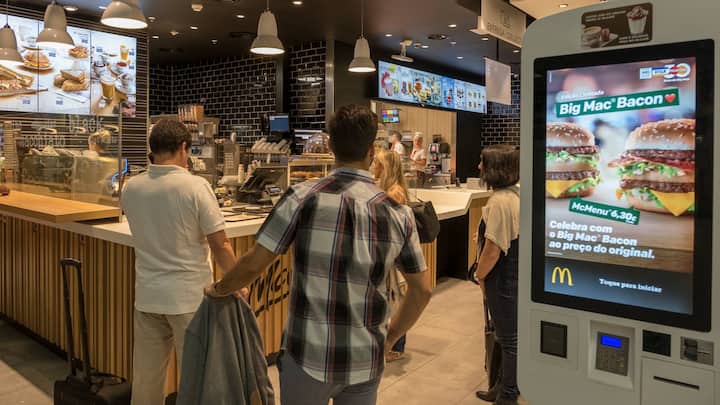 LISBON, PORTUGAL - SEPTEMBER 4: Travelers queue by McDonald's restaurant digital menu boards self-serve kiosks with touch screen in passenger area at Terminal 1 of Humberto Delgado International Airport on September 04, 2018 in Lisbon, Portugal. Portuguese tourist industry has gone through an excellent year in 2018, for the country is rated as very safe by travelers. (Photo by Horacio Villalobos - Corbis/Corbis via Getty Images)