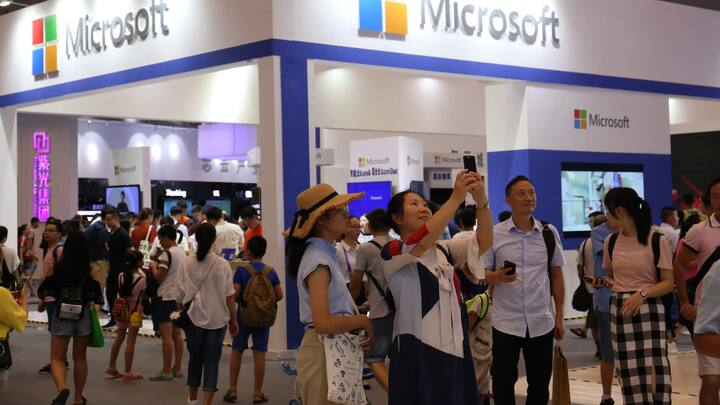 CHONGQING, CHINA - AUGUST 23: People visit the Microsoft pavilion during the Smart China Expo at Chongqing International Expo Center on August 23, 2018 in Chongqing, China. The first Smart China Expo with the theme of 'Smart Technology: Empowering Economy, Enriching Life' is held on August 23-25 in Chongqing. (Photo by VCG/VCG via Getty Images)