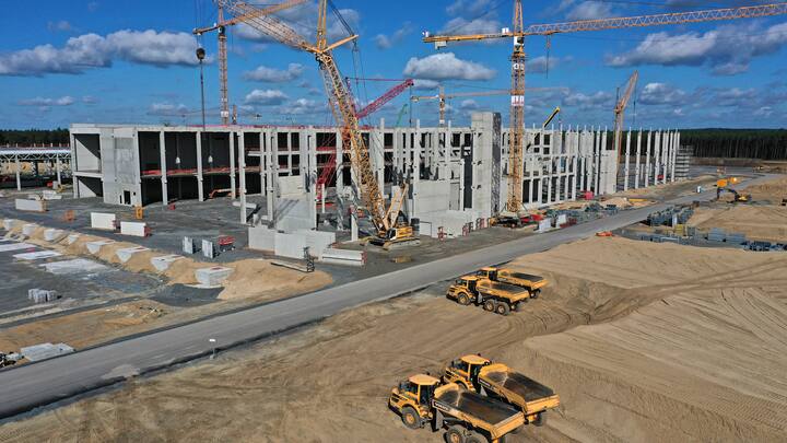 GRUENHEIDE, GERMANY - SEPTEMBER 06: In this aerial view from a drone, cranes stand among the future paint shop (L) and energy unit at the construction site of the new Tesla Gigafactory near Berlin on September 06, 2020 near Gruenheide, Germany. Tesla is planning to begin electric car production at the site by the summer of 2021 with 12,000 employees and an output of at least 100,000 cars annually.  (Photo by Sean Gallup/Getty Images)
