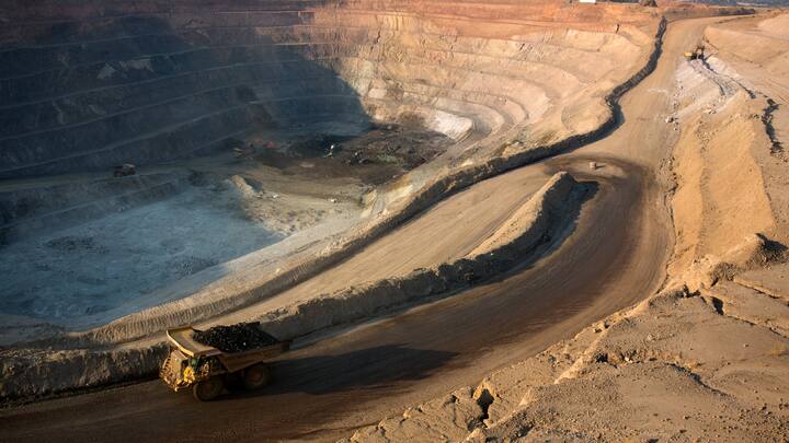 KOLWEZI, DRC- JULY 7: The sun sets on one of the open pit copper mines at Mutanda Mining Sarl on July 6, 2016 in Kolwezi, DRC. The mine is owned (69%) by Glencore, an Anglo-Swiss multinational commodity trading and mining company. The mine is mainly producing copper but also some cobalt. The mine employs about 3,500 people and its located in Luabala Province in Southern DRC. A truck carries a load of ore to the processing plant. (Photo by Per-Anders Pettersson/Getty Images)