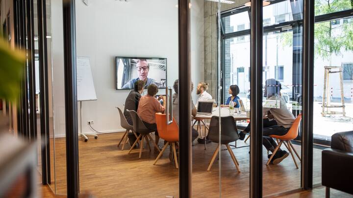 Multi-ethnic business people video conferencing in board room at office