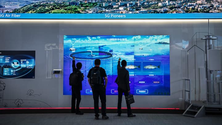 CHINA - APRIL 26: Customers look at a display showing Huawei 5G technology at the company's Bantian campus on April 26, 2019 in Shenzhen, China.