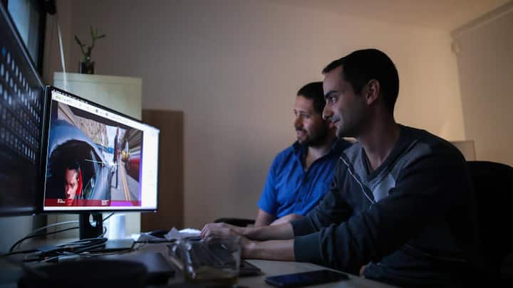 Researchers Shachar Honig (left), 35, and Sarel Duanis (right), 29, look at videos and effects in an office at Lightricks, a startup that creates applications for photo and video editing, in Jerusalem, February 28, 2019.