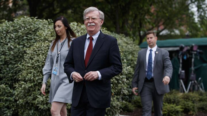 National security adviser John Bolton walks over to speak with reporters about Venezuela, outside the White House, Wednesday, May 1, 2019, in Washington. (AP Photo/Evan Vucci)