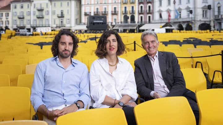 Raphael Brunschwig, Chief Operating Officer, Lili Hinstin, Artistic Director, and Marco Solari, President of the Locarno Film Festival, from left to right, pose for a photograph on the Piazza Grande in Locarno, Switzerland, on August 5, 2019. (KEYSTONE/Christian Beutler)