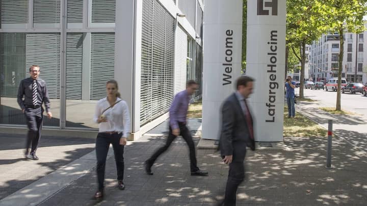 The new logo of LafargeHolcim on panels in front of the head quarters in Zurich, Switzerland, on Wednesday, 15 July 2015. LafargeHolcim today officially launched the new Group around the world and announced key elements of its ambitions for the future. (KEYSTONE/Patrick B. Kraemer)