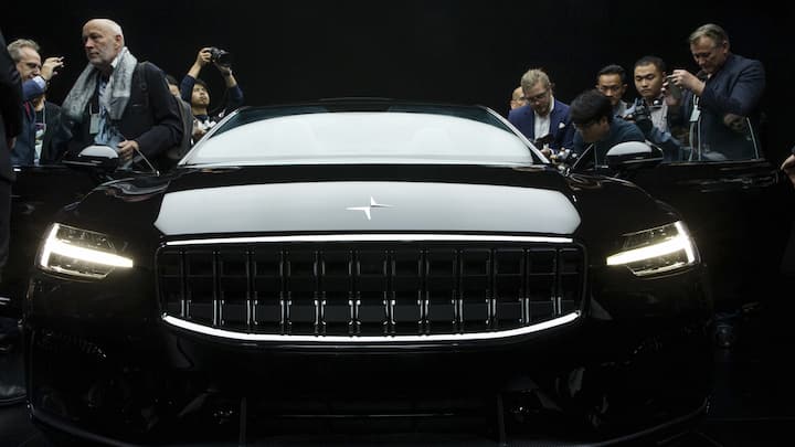 Attendees look at the the Polestar 1 during its unveiling in Shanghai, China Tuesday Oct. 17, 2017. Volvo Cars' performance electric car brand, Polestar, unveiled a four-seat coupe in lightweight carbon fiber as its first model Tuesday, adding to competition in a market dominated until now by Tesla. (Chinatopix Via AP) CHINA OUT