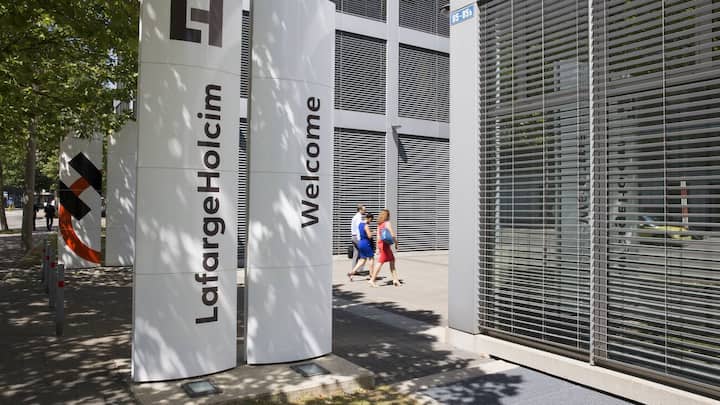 The new logo of LafargeHolcim on panels in front of the head quarters in Zurich, Switzerland, on Wednesday, 15 July 2015. LafargeHolcim today officially launched the new Group around the world and announced key elements of its ambitions for the future. (KEYSTONE/Patrick B. Kraemer)