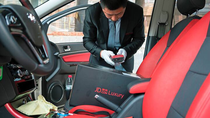 Tang Hongliang, a driver for the JD.com luxury service, gets ready to start the workday in Beijing, June 29, 2017. To court the luxury market, companies like JD.com are using their customer base to offer upscale retailers support on things like white glove deliveries. (Giulia Marchi/The New York Times)