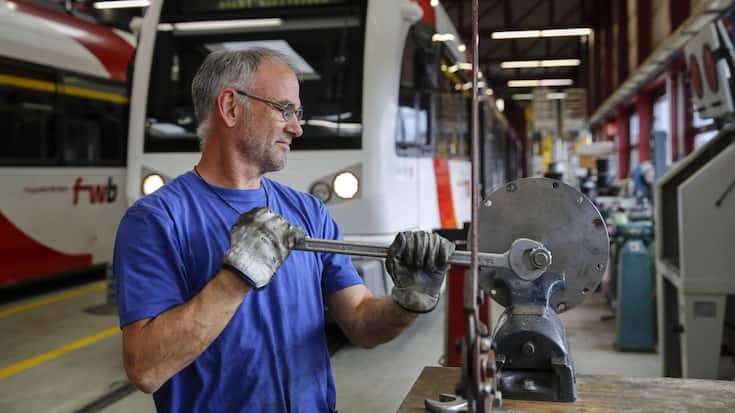 An employee services components at the Stadler Rail AG service facility in Wil, Switzerland, on Tuesday, Oct. 8, 2019