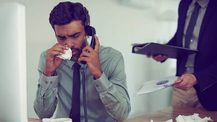 Cropped shot of a businessman suffering with allergies in an office