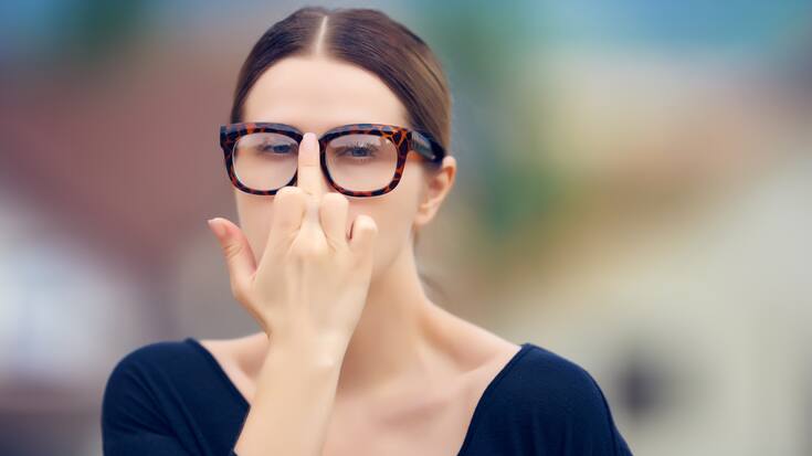 portrait of cool student with nerd eyeglasses arranging her eyewear/showing obscene gesture.