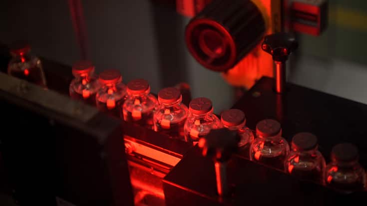 This picture taken in Monts, central France, on April 22, 2021, shows vials of the Moderna Covid-19 disease vaccine at Recipharm plant. - Recipharm has been chosen by the American biotech Moderna to produce part of its candidate vaccine against Covid-19 in France. (Photo by GUILLAUME SOUVANT / AFP)