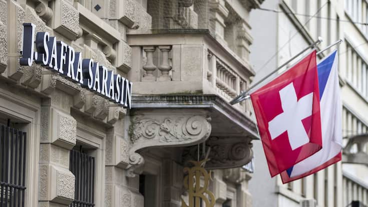 Das Logo der Schweizer Privatbank J. Safra Sarasin, eine Schweizer Fahne und eine Zuercher Fahne, aufgenommen am Paradeplatz, am Sonntag, 27. April 2014, in Zuerich. (KEYSTONE/Patrick B. Kraemer)