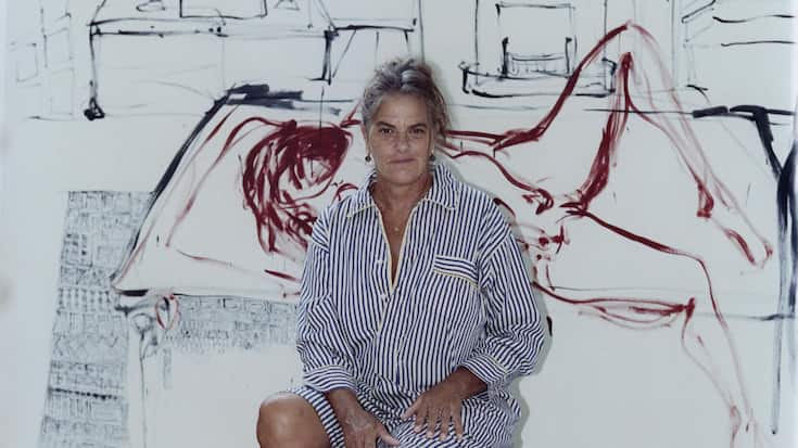Tracey Emin with a painting in progress at her studio in Margate, England, Sept. 28, 2023. (Charlie Gates/The New York Times)