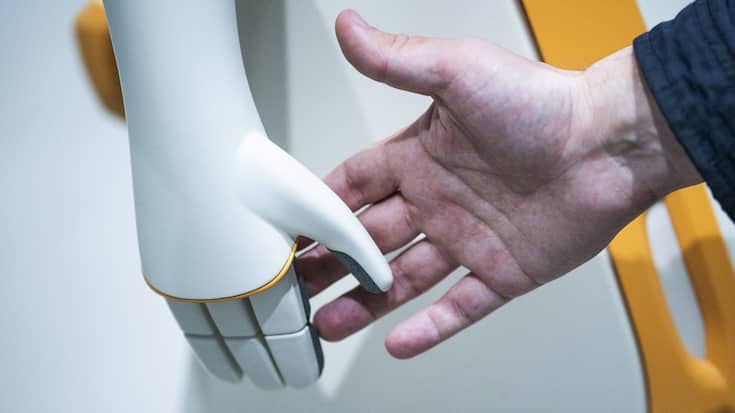 A visitor touches a PAL Robotic robot during the Mobile World Congress 2023 in Barcelona, Spain, on Wednesday, March 1, 2023. After three years of pandemic disruption, MWC, also known as Mobile World Congress, kicked off Monday in Barcelona, Spain, with mobile phone makers showing off new devices and telecom industry executives perusing the latest networking gear and software. (AP Photo/Joan Mateu Parra)