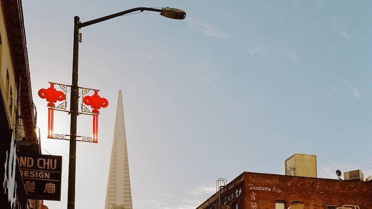 Exterior view of building and skyscraper with car parked on street, San Francisco, California, United States Of America