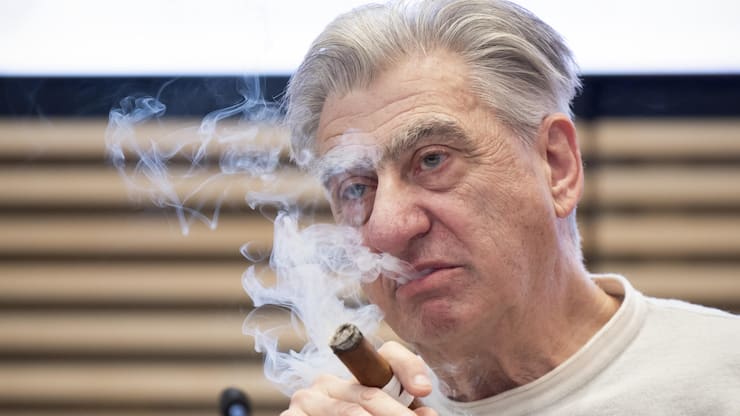 Nick Hayek, CEO Swatch Group AG, smokes a cigar during a press conference to present the annual results for 2024, Wednesday, March 19, 2025, in Biel, Switzerland. (KEYSTONE/Peter Klaunzer)