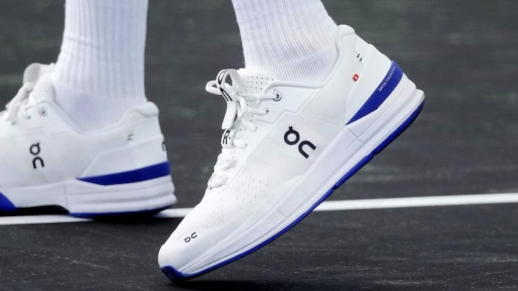 Switzerland's Roger Federer sports a pair of shoes as he attends a training session ahead of the Laver Cup tennis tournament at the O2 in London, Wednesday, Sept. 21, 2022. Federer appeared earlier at a news conference to discuss his retirement from professional tennis at age 41 after a series of knee operations. He will close his career with a doubles match at the Laver Cup on Friday . (AP Photo/Kin Cheung)