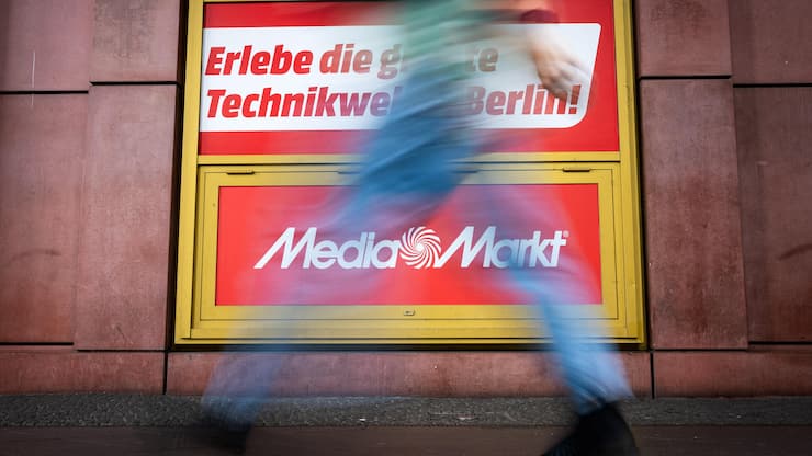 BERLIN, GERMANY - JULY 31: People walk past a MediaMarkt sign outside a MediaMarkt consumer electronics store on July 31, 2025 in Berlin, Germany. Chinese online retailer JD.com is planning to acquire Ceconomy, which owns both the Saturn and MediaMarkt chains. Both brands have stores across Europe. (Photo by Christian Mang/Getty Images)