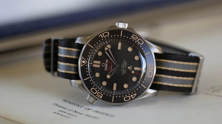 Die 2019 vorgestellte Seamaster Diver 300M «No Time To Die» aus Titan brachte eine Rückkehr der Keramik- zur Aluminium-Einlage für den einseitig rastenden Drehring, ein stark gewölbtes Saphirglas und militärische Ordonnanzzeichen. Sie wurde umgehend zum Bestseller – und zur Blaupause für aktuell vier weitere Modelle ähnlicher Bauart.