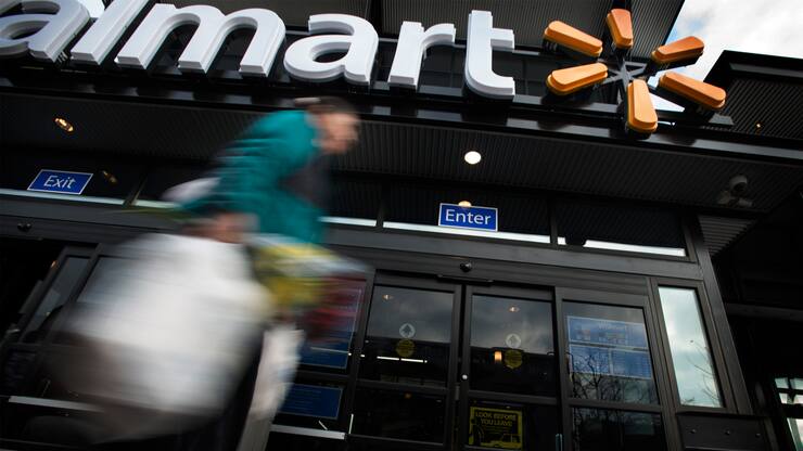 WASHINGTON, DC - DECEMBER  4: A customer departs Walmart on the opening day of the store on Georgia Ave. in Washington, DC on December 4, 2013. (Photo by Bonnie Jo Mount/The Washington Post via Getty Images)