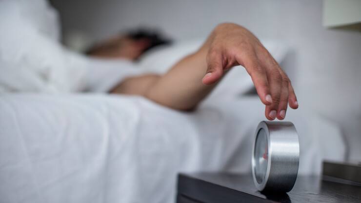 Cape Town, South Africa, young male reaches to turn off alarm clock