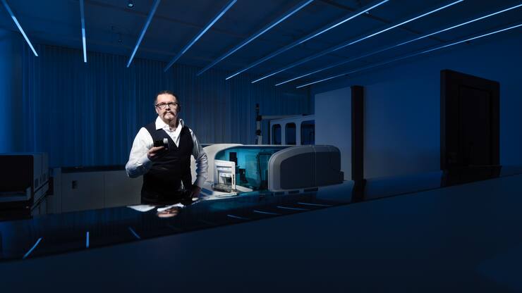 PD Dr. med. Michael Hombach, Director, Senior Global Clinical Leader Infectious Diseases poses with a Elecsys Anti-SARS-CoV-2 test next to a Cobas Elecsys 801 machine at Roche Diagnostics in Rotkreuz, Canton of Zug, Switzerland on May 15, 2020.  Photo: Â© 2020 Michael Buholzer