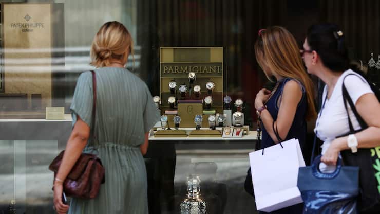 Pedestrian look at a display of Parmigiani Fleurier SA wristwatches displayed in the window of a luxury watch store in Athens, Greece, on Tuesday, July 7, 2015. Europe's most indebted country is closer than ever to an exit from the euro zone, with banks low on cash and creditor nations led by Germany running even lower on patience. Photographer: Chris Ratcliffe/Bloomberg
