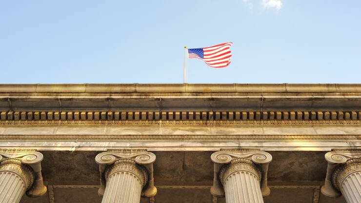 An American flag hoisted on the Federal Reserve Building in Washington, D.C.