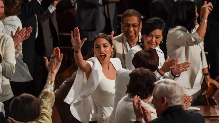 WASHINGTON, DC - FEBRUARY 05:Rep. Alexandria Ocasio-Cortez (D-N.Y.) high-fives other congresswomen after President Donald J. Trump acknowledged newly elected female members of congress during the State of the Union address before members of Congress in the House chamber of the U.S. Capitol February 5, 2019 in Washington, DC.  (Photo by Toni L. Sandys/The Washington Post via Getty Images)