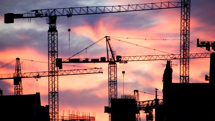 A building site at sunset with cranes silhouetted against a red sky, 2007. Artist: Historic England Staff Photographer. (Photo English Heritage/Heritage Images/Getty Images)