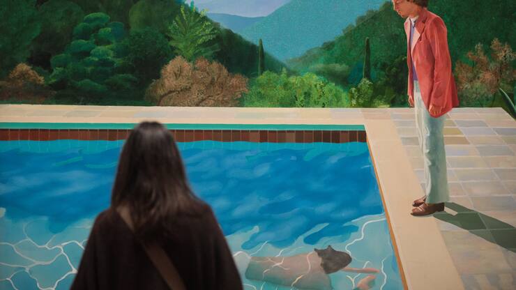 A visitor views 'Portrait of an Artist (Pool with Two Figures)', 1972 by David Hockney during a press preview for the British artists' retrospective at Tate Britain on February 6, 2017 in London, England. The exhibition covers six decades of Hockney's life from his time as a student in the early 1960s to more recent works completed in Los Angeles. The retrospective runs from February 09 - 29 May, 2017. (Photo by Jack Taylor/Getty Images)