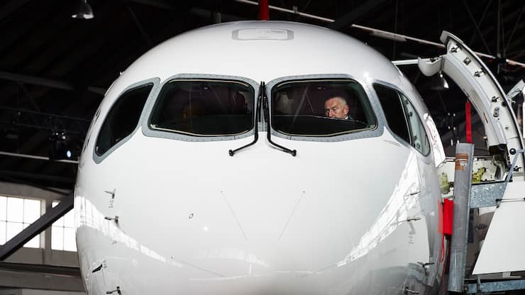 Swiss International Airlines Chief Executive Officer Thomas Kluehr sits in the cockpit of the Air Lines' new Bombardier CS 100 passenger jetliner during a media presentation at the Zurich Airport in Zurich on July 6, 2016. - Swiss International Air Lines' new Bombardier CS 100 jetliner is the first rolled out aircraft of the Canadian Bombardier Commercial Aircraft's new jetliner C-Series aircrafts. (Photo by MICHAEL BUHOLZER / AFP)