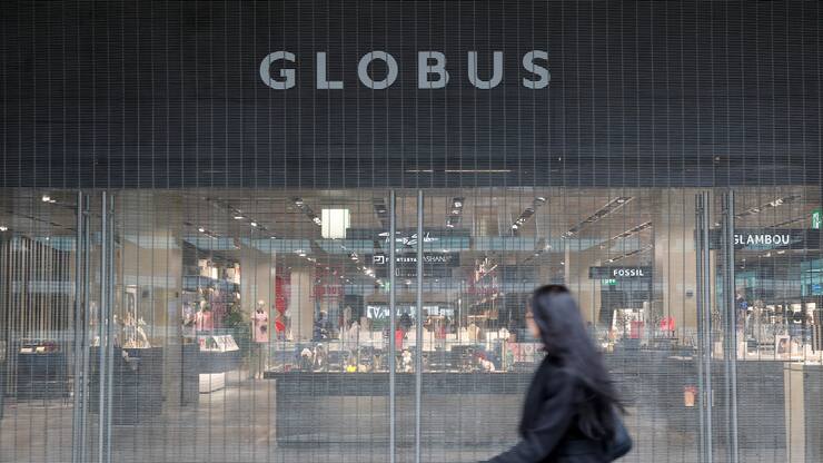 A woman walks past the entrance of a Globus department store in Zurich, Switzerland February 4, 2020. REUTERS/Arnd Wiegmann