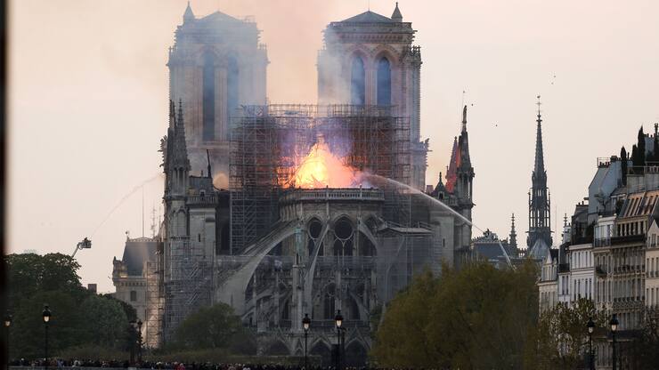 Flames and smoke are seen billowing from the roof at Notre-Dame Cathedral in Paris on April 15, 2019. A fire broke out at the landmark Notre-Dame Cathedral in central Paris, potentially involving renovation works being carried out at the site, the fire service said.Images posted on social media showed flames and huge clouds of smoke billowing above the roof of the gothic cathedral, the most visited historic monument in Europe. (Photo by Michel Stoupak/NurPhoto via Getty Images)