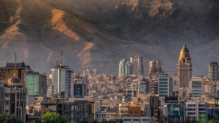 Tehran city building at the feet of the Alborz mountain range separating the rest of Iran from the Caspian sea basin, displaying the growth and development experienced by the Iranian capital.