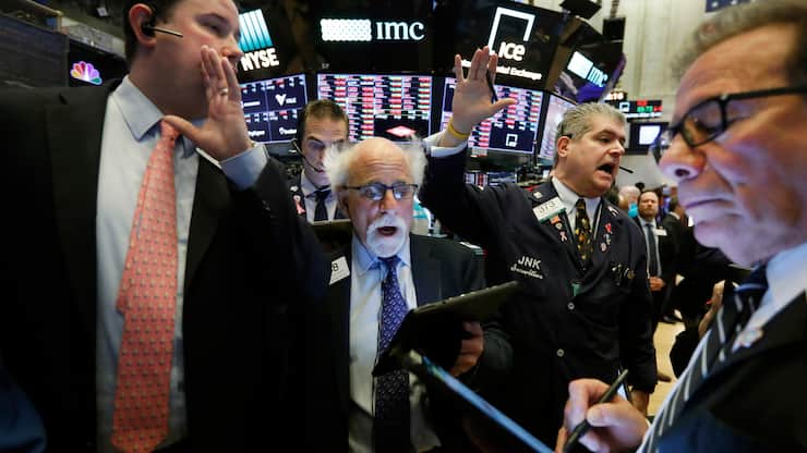 New York Stock Exchange Floor Governor Brendan Connolly, left, works with traders Peter Tuchman, John Panin and Sal Suarino, second left to right, on the floor of the NYSE, March 9, 2020. (AP Photo/Richard Drew)